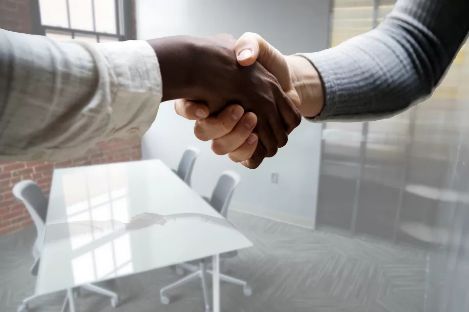 Close-up of a handshake in an office